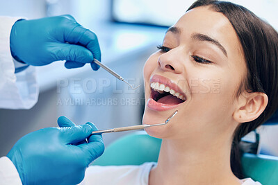 Buy stock photo Shot of a young woman getting her teeth done by her dentist