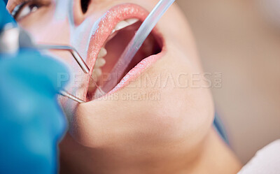 Buy stock photo Shot of a woman getting her teeth cleaning by her dentist