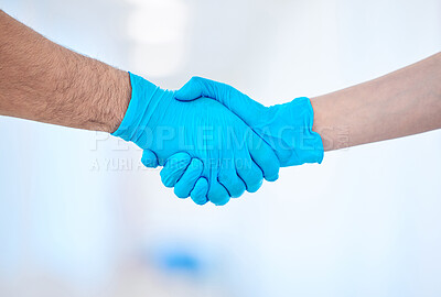 Buy stock photo Shot of a two dental coworkers shaking hands