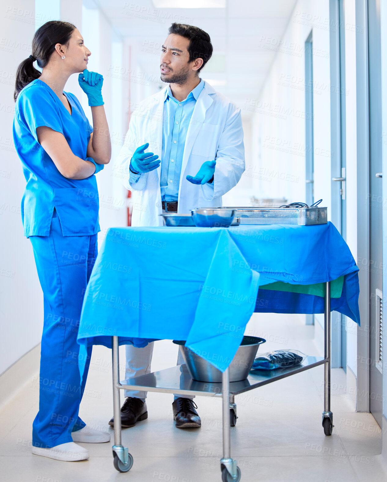 Buy stock photo Shot of a dentist speaking about equipment with his assistant