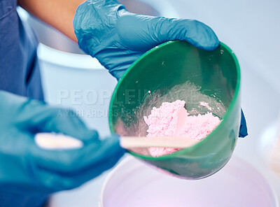 Buy stock photo Shot of a dentist mixing a bowl of powder before a procedure