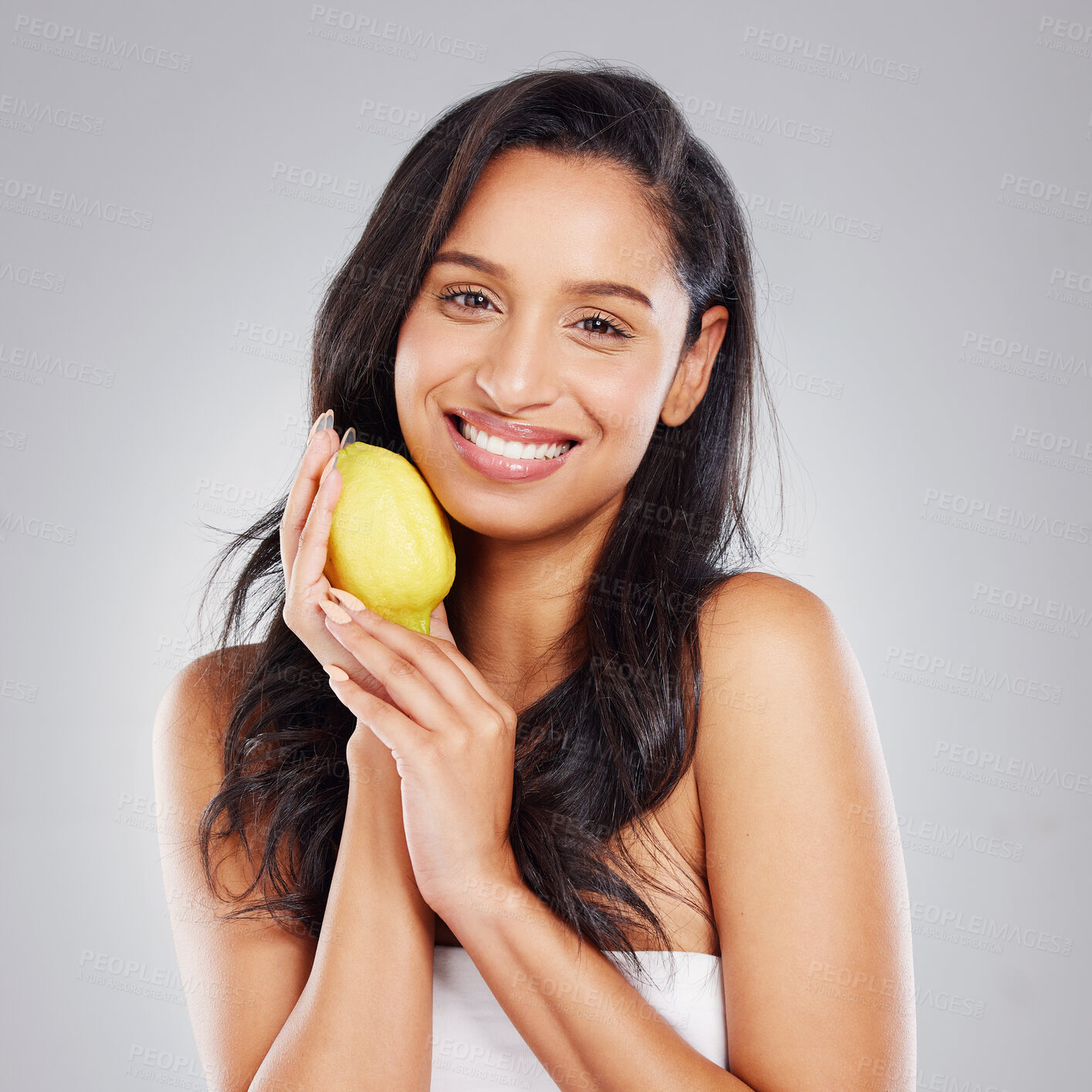 Buy stock photo Girl, portrait and happy with lemon in studio for skincare, natural cosmetics and vitamin c for organic facial treatment for hydration. Woman, shine and citrus fruit on gray background for collagen.