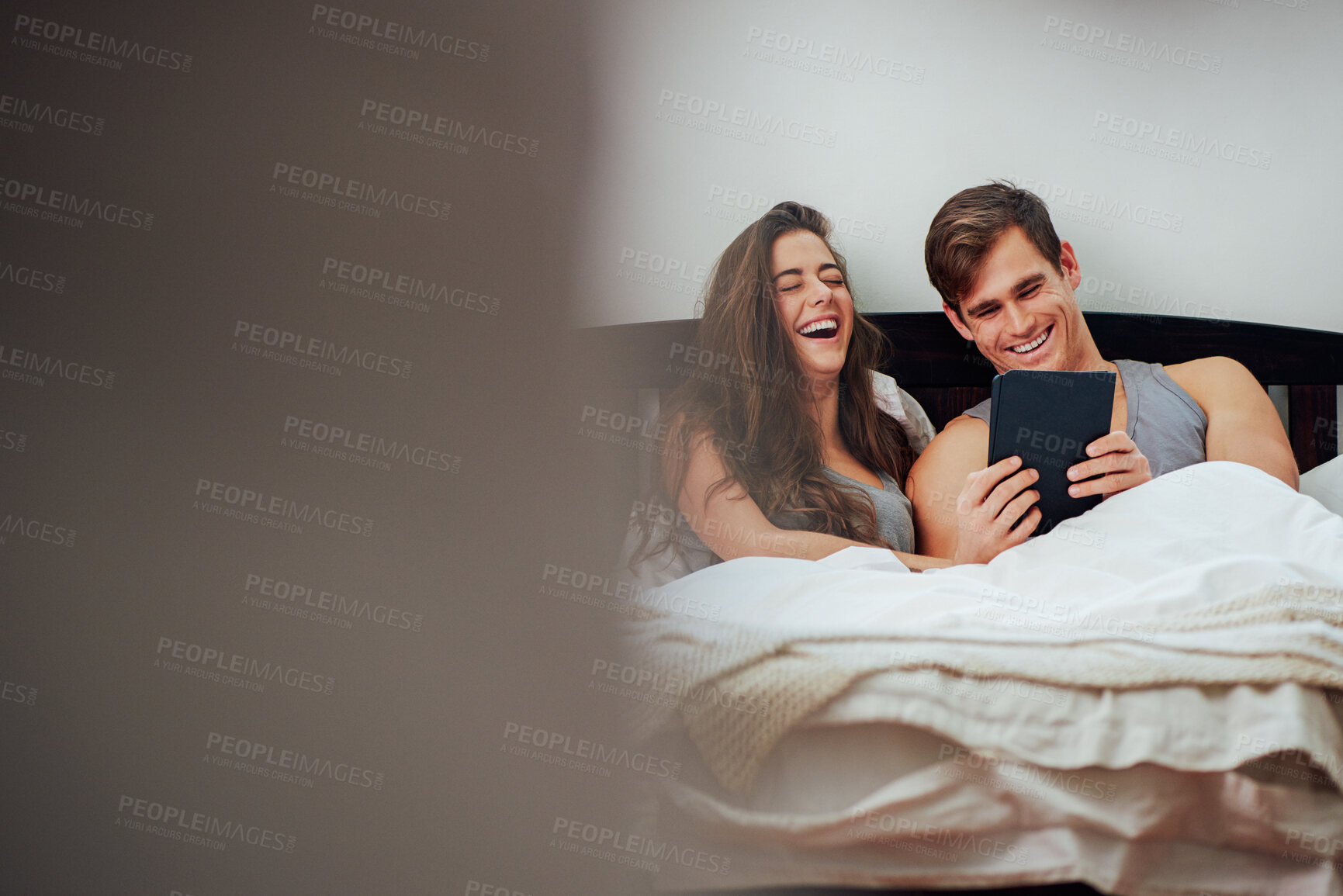 Buy stock photo Couple, tablet and laughing in bed, home and relax with funny meme, video and social media in morning. Woman, man and happy with digital touchscreen, app and streaming with comedy movie at apartment