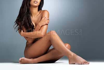 Buy stock photo Studio portrait of a sexy young woman posing nude against a grey background