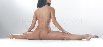 Buy stock photo Studio shot of a gorgeous young woman doing splits while naked against a grey background