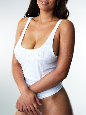 Buy stock photo Studio portrait  of a sexy young woman posing half naked against a grey background