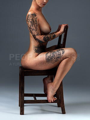 Buy stock photo Full length shot of a beautiful young woman posing nude on a chair in the studio