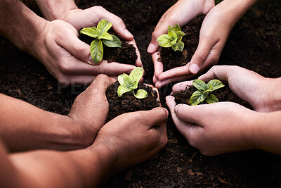 Buy stock photo High angle shot of a group of unrecognizable people holding plants growing out of soil