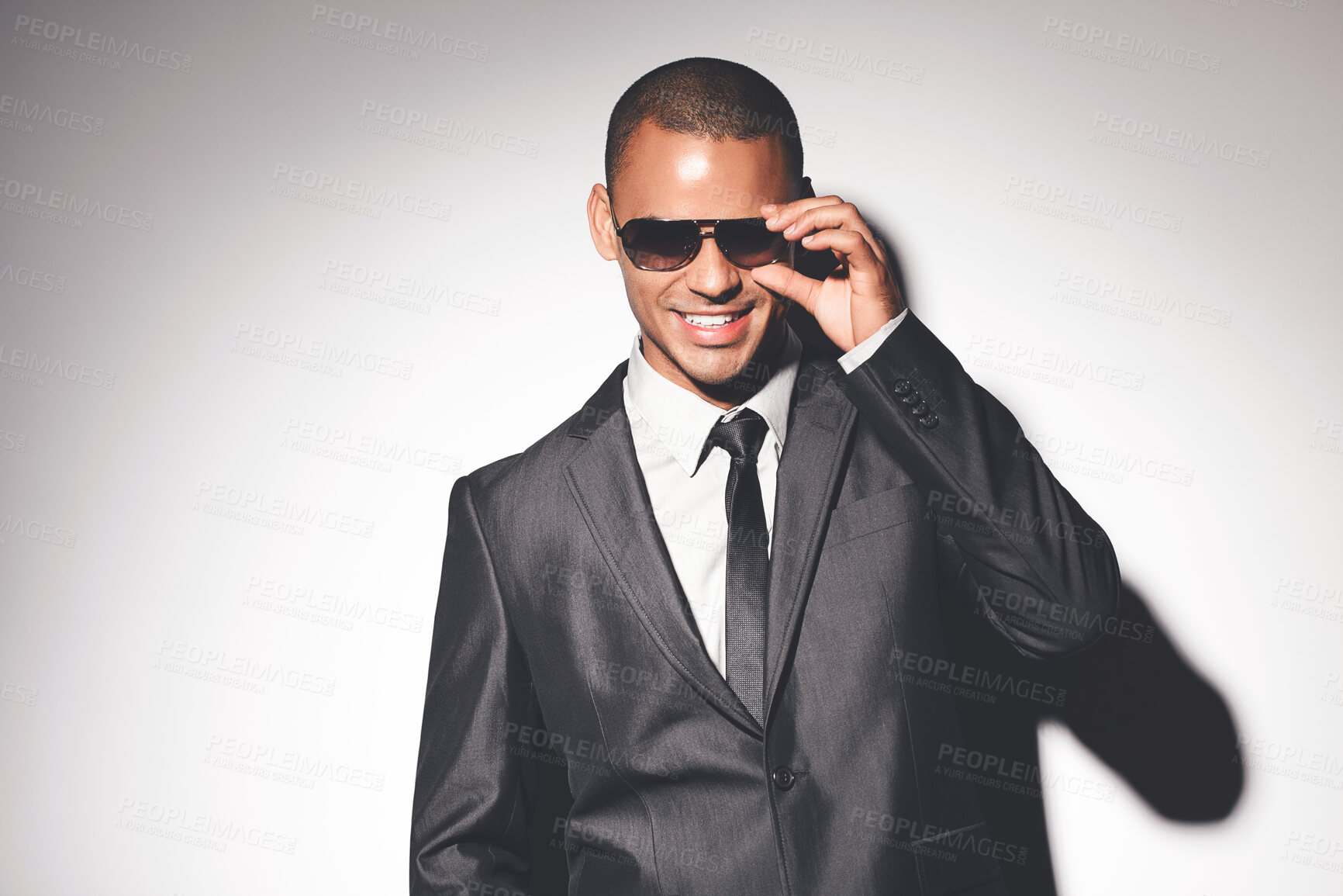 Buy stock photo Man, suit and sunglasses in studio with smile for confidence, fashion and job as spy by white background. Person, bodyguard or government agent with style for secret international mission in London