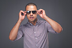 Man fashion model posing against a studio background