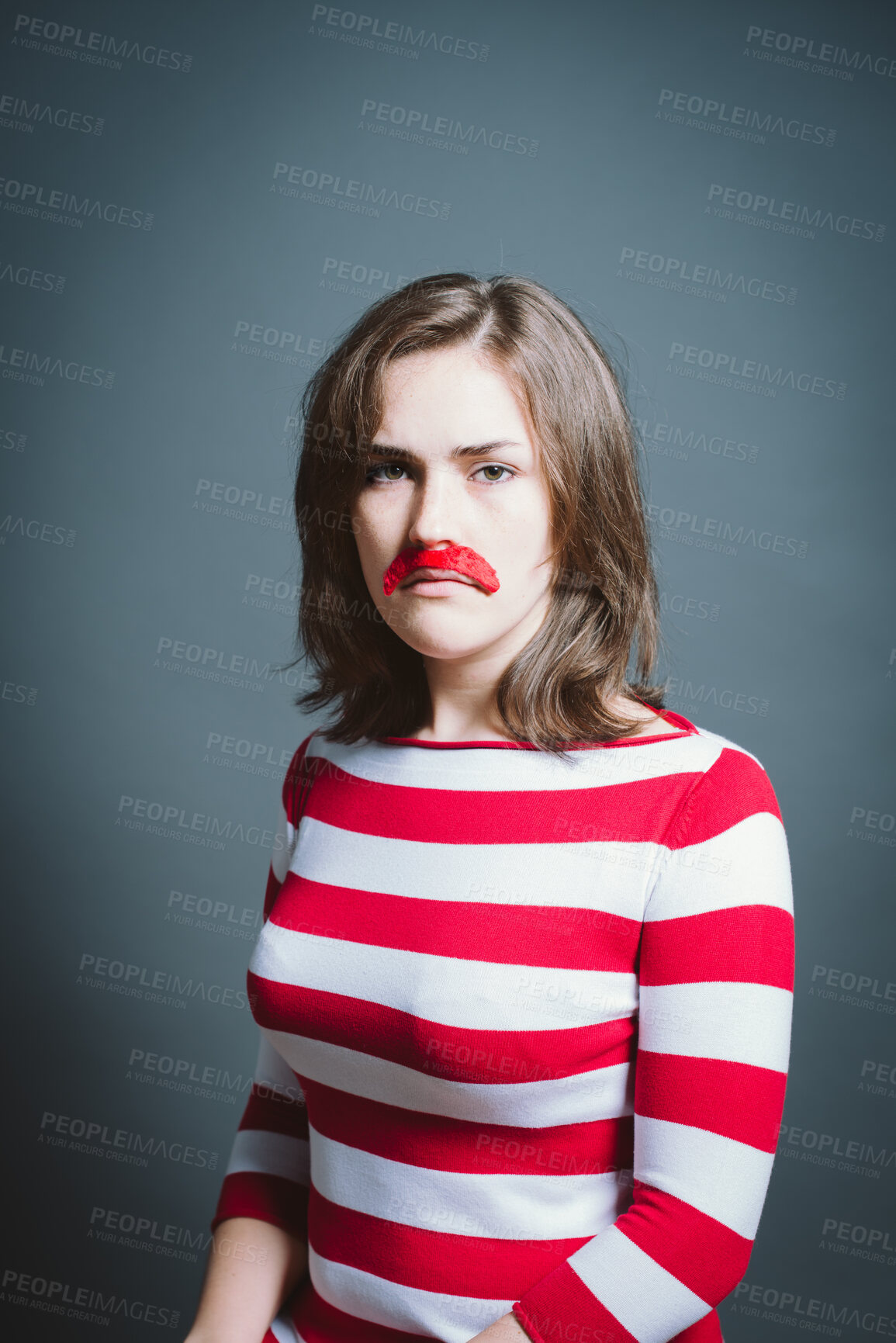 Buy stock photo Studio, portrait and sad woman with moustache for character, facade and cosplay with pride for halloween. Female person, creativity and ready by gray background for persona, red costume and serious