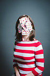 Young woman wearing mask against a grey background in studio