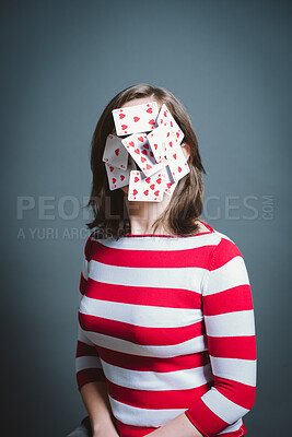 Buy stock photo Playing cards, mask and woman in studio with gambling, games or casino betting addiction. Mental health, disguise and person with poker face, hidden identity or mime character on grey background.