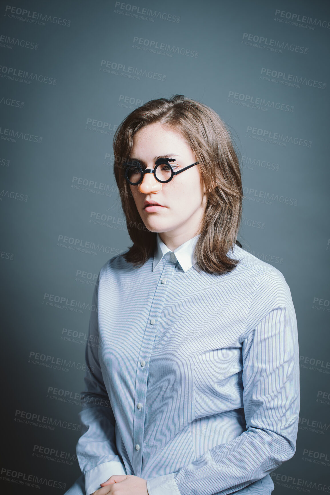 Buy stock photo Woman, thinking and fake glasses for mask, cosplay and halloween photo booth with vision in studio. Female person, quirky and disguise on gray background for character, persona and birthday event