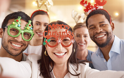 Buy stock photo Portrait of a group of businesspeople taking selfies together during a Christmas party at work