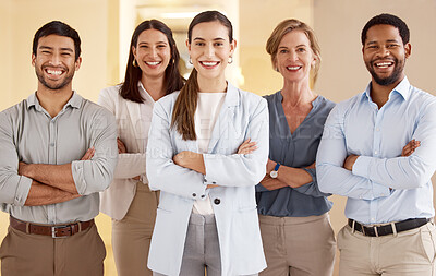 Buy stock photo Portrait of a diverse group of businesspeople standing together with their arms crossed in an office