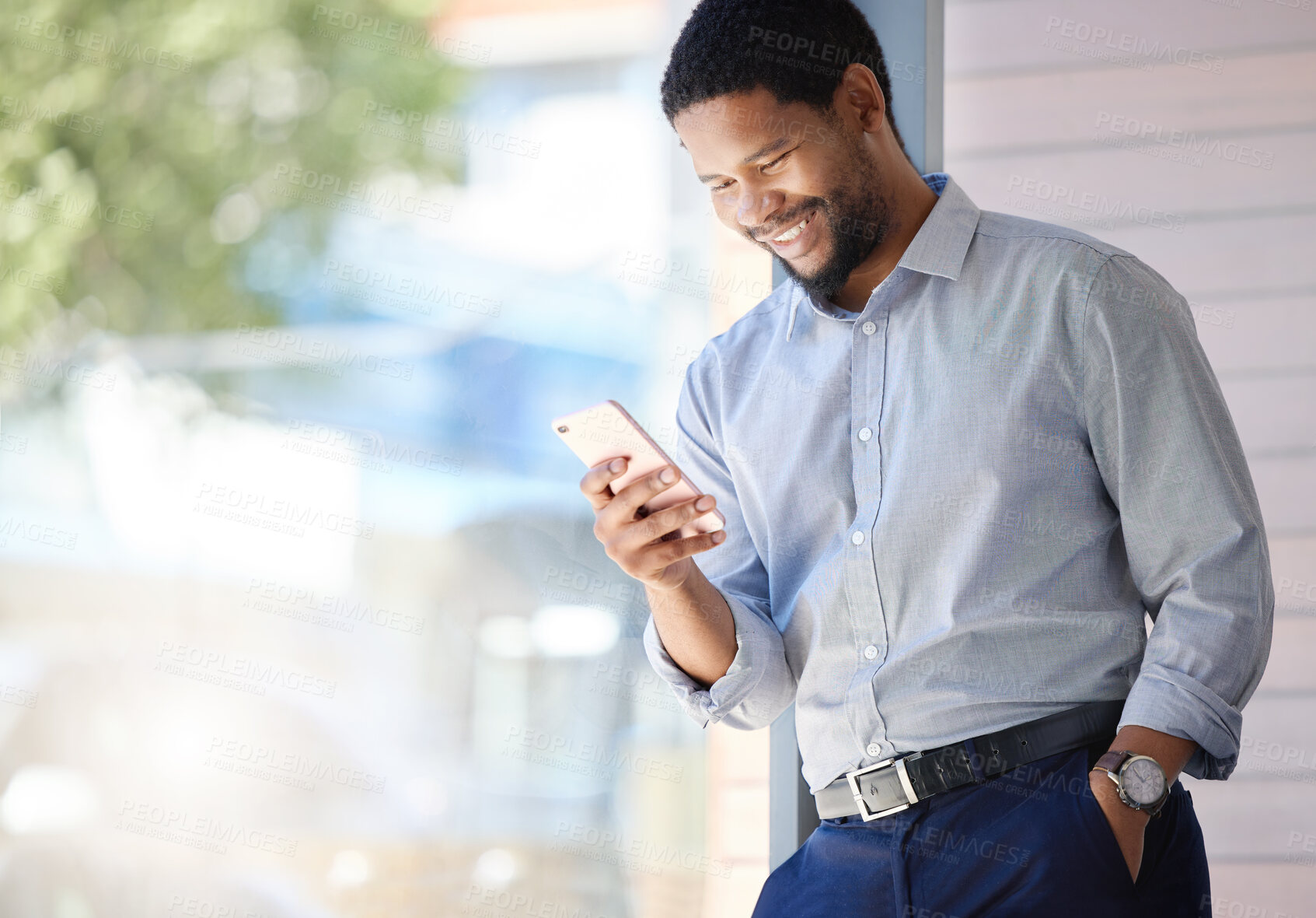 Buy stock photo Businessman, typing and reading with phone by window for communication, social media or news at office. Black man, employee or smile on mobile smartphone for online chatting or texting at workplace