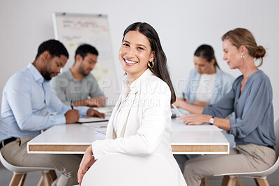 Buy stock photo Cropped portrait of an attractive young businesswoman sitting in the boardroom during a meeting with her colleagues