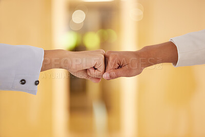 Buy stock photo Closeup shot of two unrecognisable businesspeople giving each other a fist bump in an office