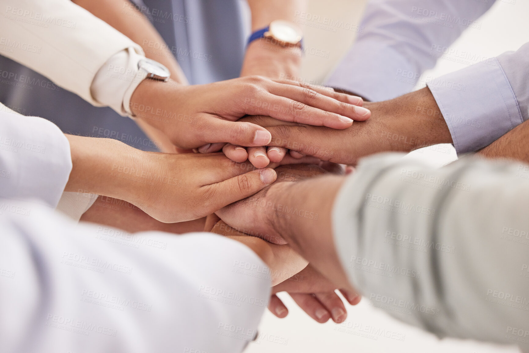 Buy stock photo Closeup shot of a group of unrecognisable businesspeople joining their hands together in a huddle in an office