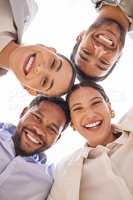 Buy stock photo Low angle shot of a group of businesspeople standing with their heads together in a huddle