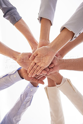 Buy stock photo Low angle shot of a group of unrecognisable businesspeople joining their hands together in a huddle in an office