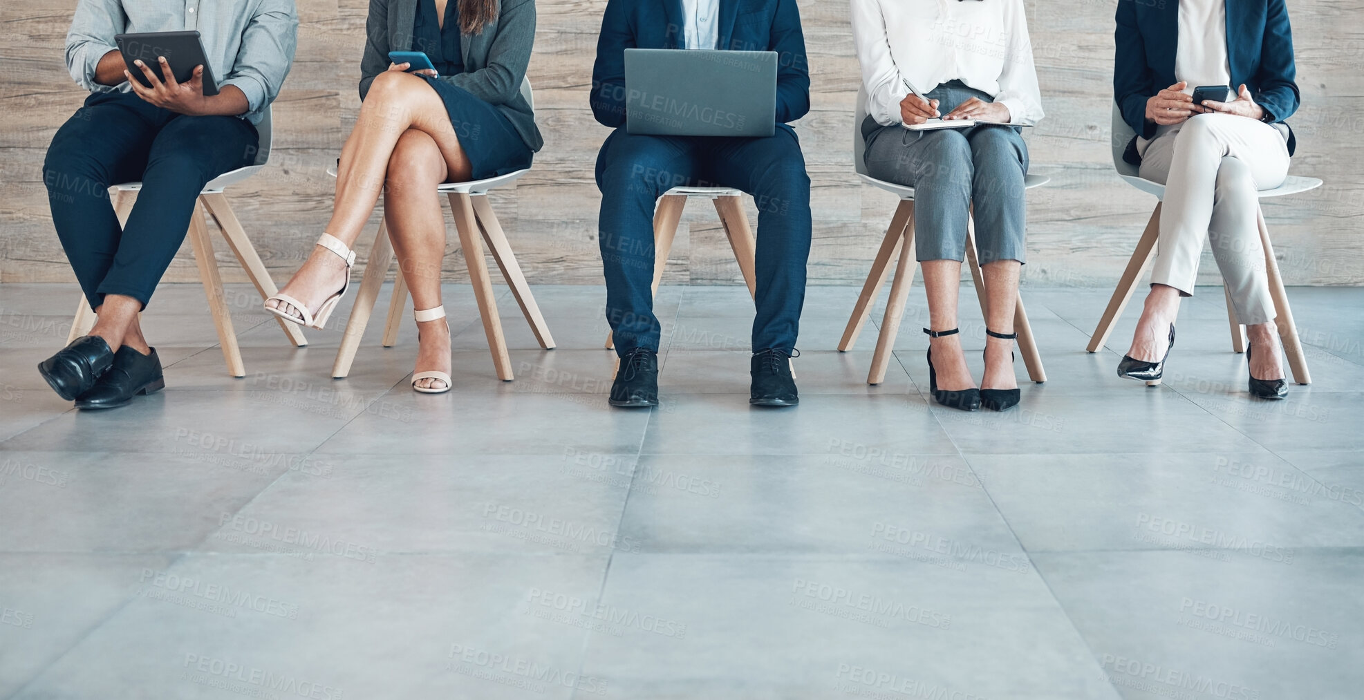 Buy stock photo Group, recruitment or legs on chair with tech for interview, strategy with onboarding in office. Business people, row or corporate with staff diversity for human resource, inclusion or research