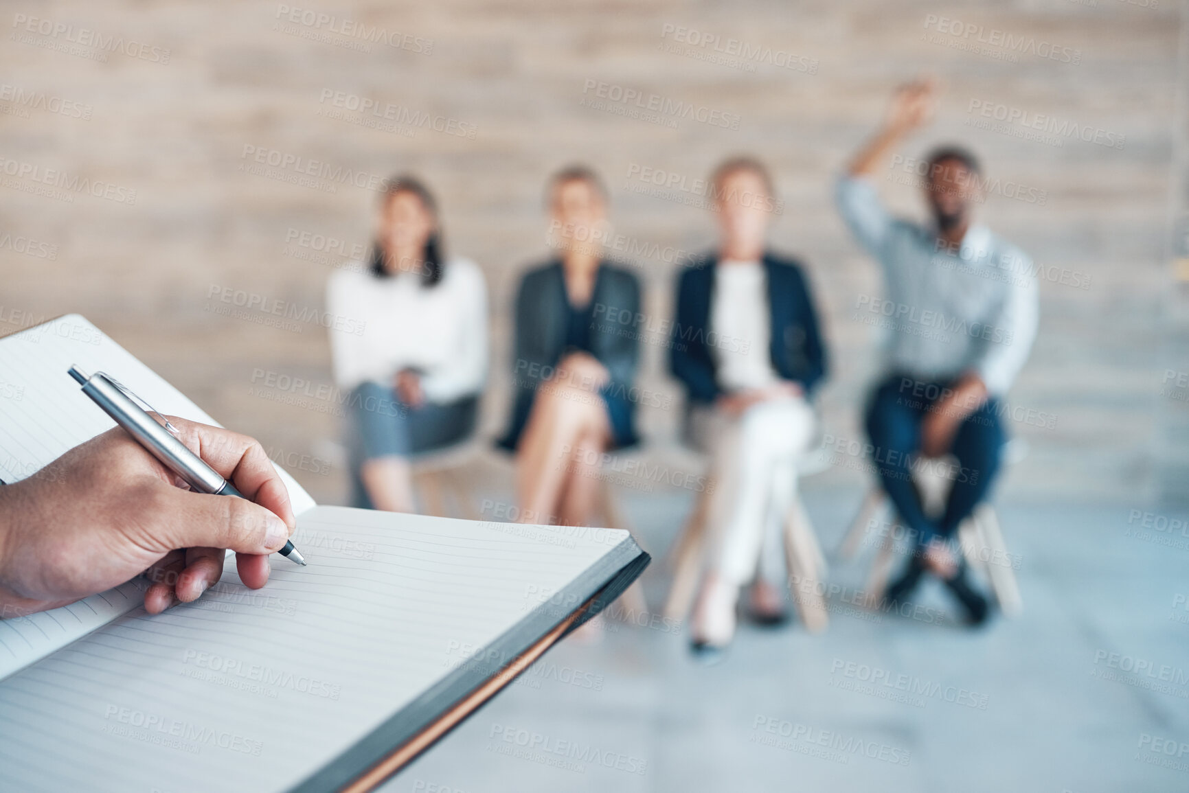 Buy stock photo Cropped shot of an unrecognisable businessman writing in a notebook while hosting interviews in the office