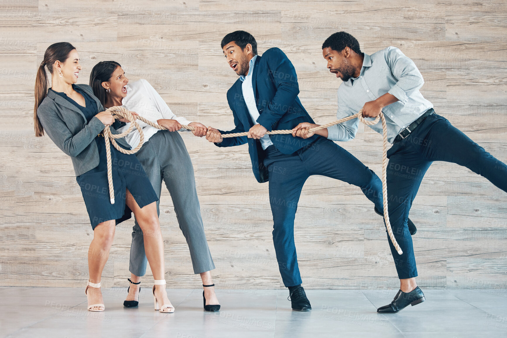 Buy stock photo Full length shot of a diverse group of businesspeople standing in the office together and tugging at rope