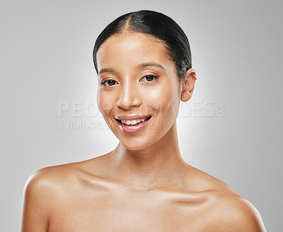 Buy stock photo Studio portrait of an attractive young woman posing against a grey background