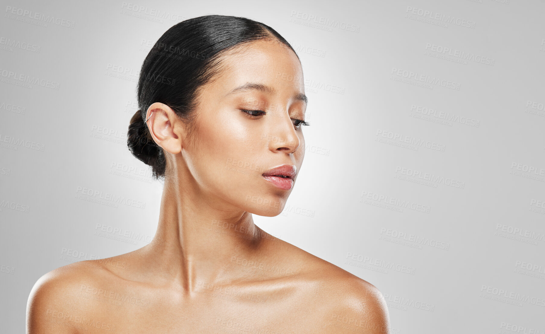 Buy stock photo Studio shot of an attractive young woman posing against a grey background