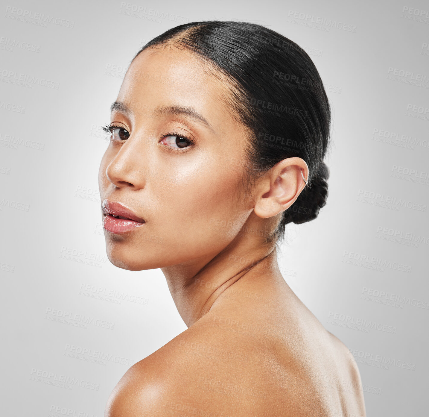 Buy stock photo Studio portrait of an attractive young woman posing against a grey background