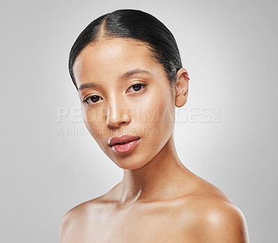 Buy stock photo Studio portrait of an attractive young woman posing against a grey background