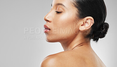 Buy stock photo Studio shot of an attractive young woman posing against a grey background