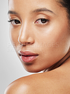 Buy stock photo Studio portrait of an attractive young woman posing against a grey background