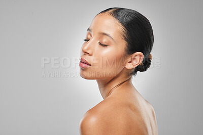 Buy stock photo Studio shot of an attractive young woman posing against a grey background