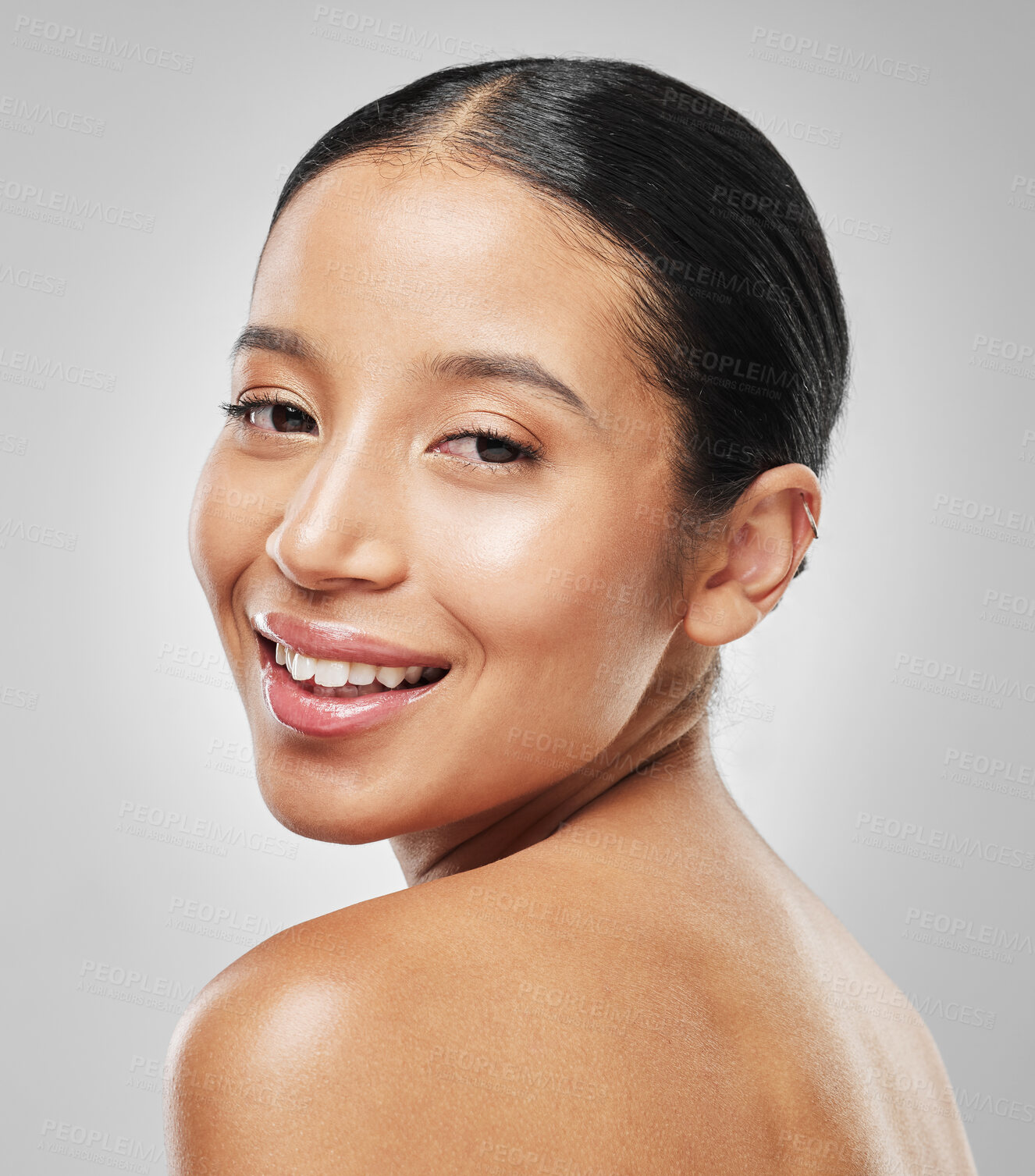 Buy stock photo Studio portrait of an attractive young woman posing against a grey background