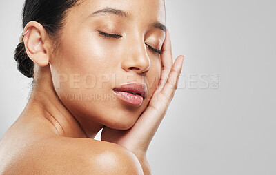 Buy stock photo Studio shot of an attractive young woman posing against a grey background