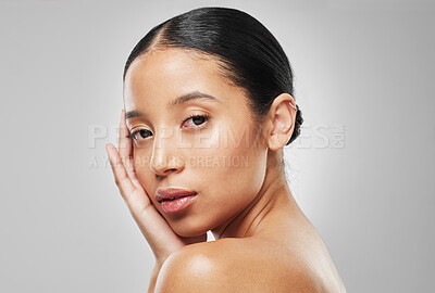 Buy stock photo Studio portrait of an attractive young woman posing against a grey background