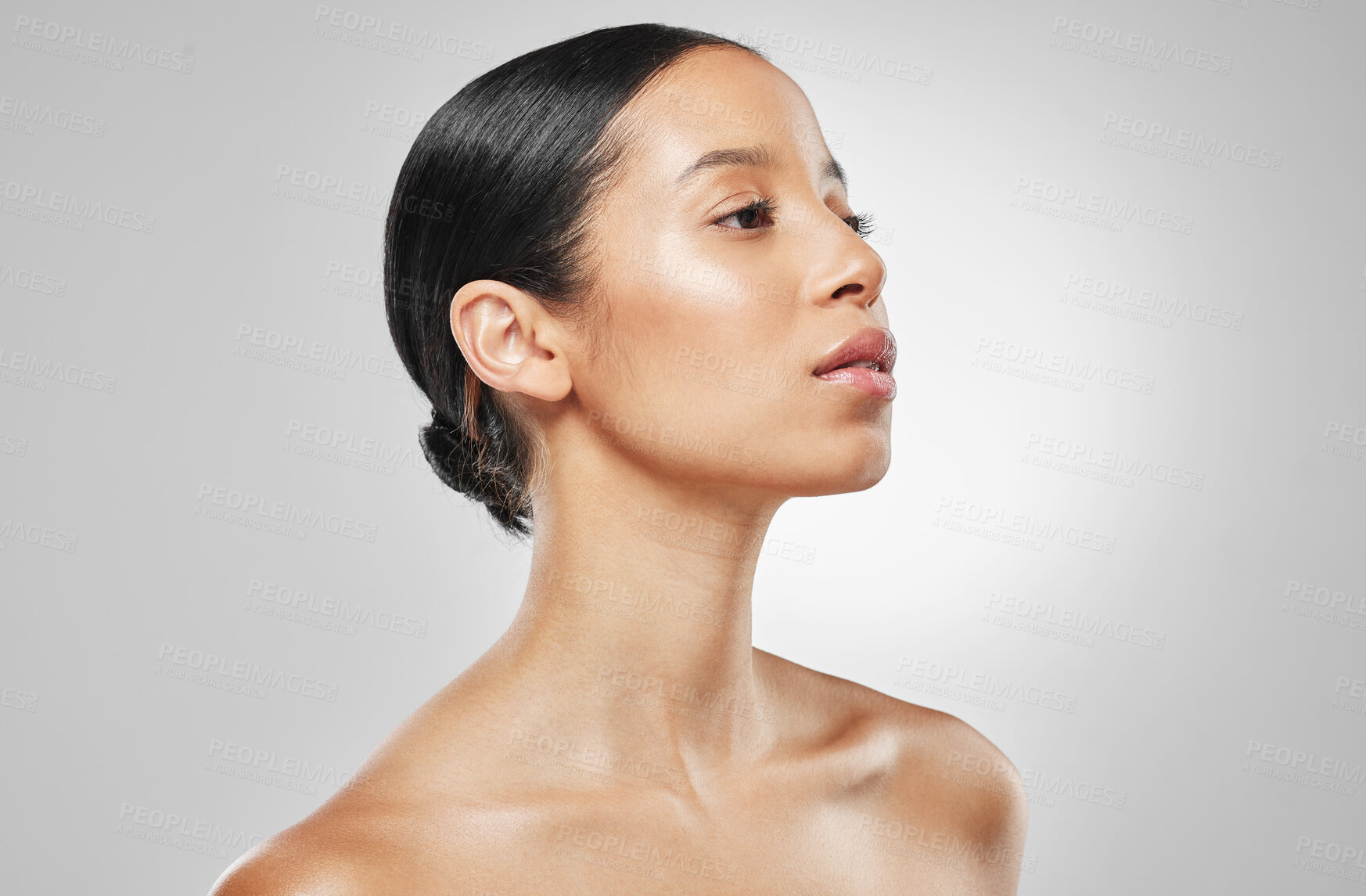 Buy stock photo Studio shot of an attractive young woman posing against a grey background