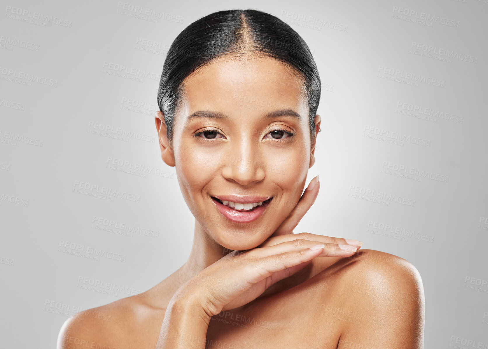 Buy stock photo Studio portrait of an attractive young woman posing against a grey background