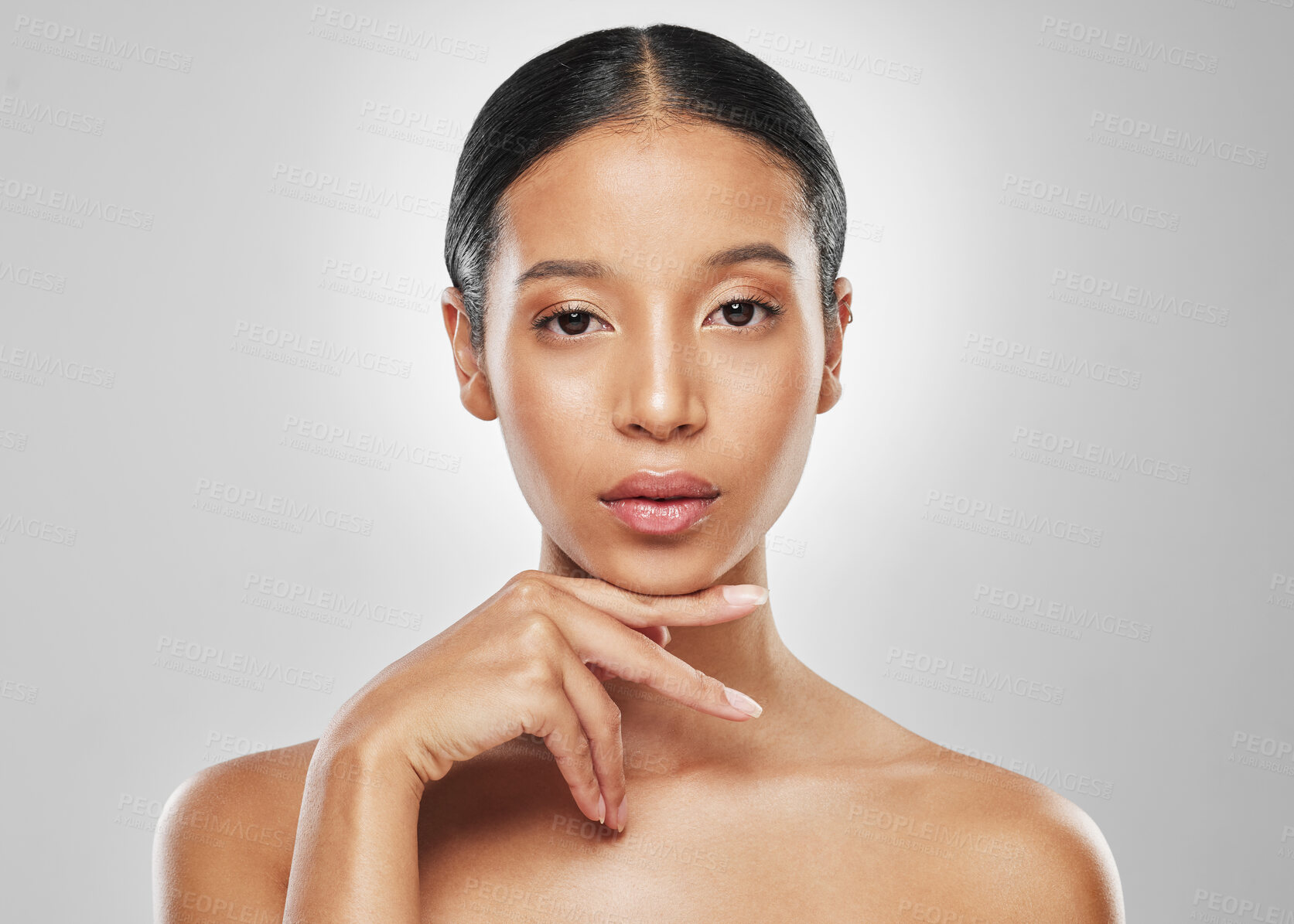 Buy stock photo Studio portrait of an attractive young woman posing against a grey background