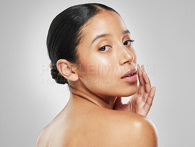 Buy stock photo Studio portrait of an attractive young woman posing against a grey background