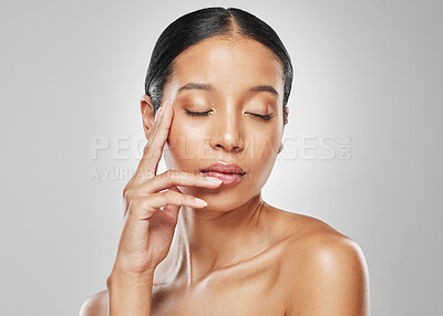 Buy stock photo Studio shot of an attractive young woman posing against a grey background