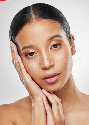 Buy stock photo Studio portrait of an attractive young woman posing against a grey background