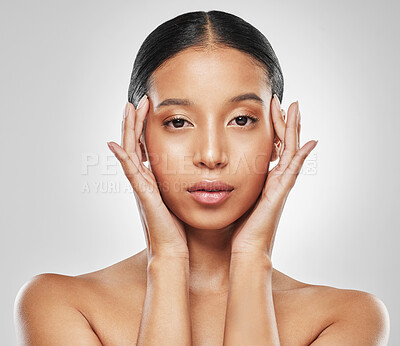 Buy stock photo Studio portrait of an attractive young woman posing against a grey background