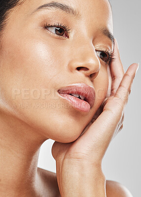 Buy stock photo Studio shot of an attractive young woman posing against a grey background