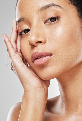 Buy stock photo Studio portrait of an attractive young woman posing against a grey background