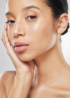 Buy stock photo Studio portrait of an attractive young woman posing against a grey background