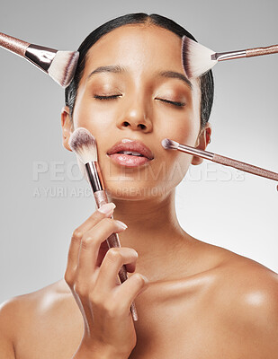 Buy stock photo Studio shot of an attractive young woman having makeup applied to her face against a grey background